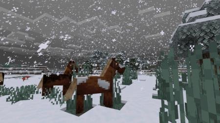 Лошади стоят под красивым снегопадом