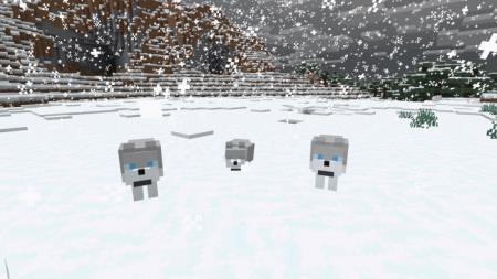 Три снежных волка во время снегопада