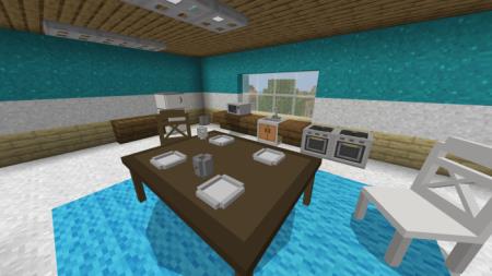 Просторная кухня со столом посередине, стоящем на красивом голубом паласе