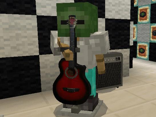 Игрок с головой зомби держит в руке гитару