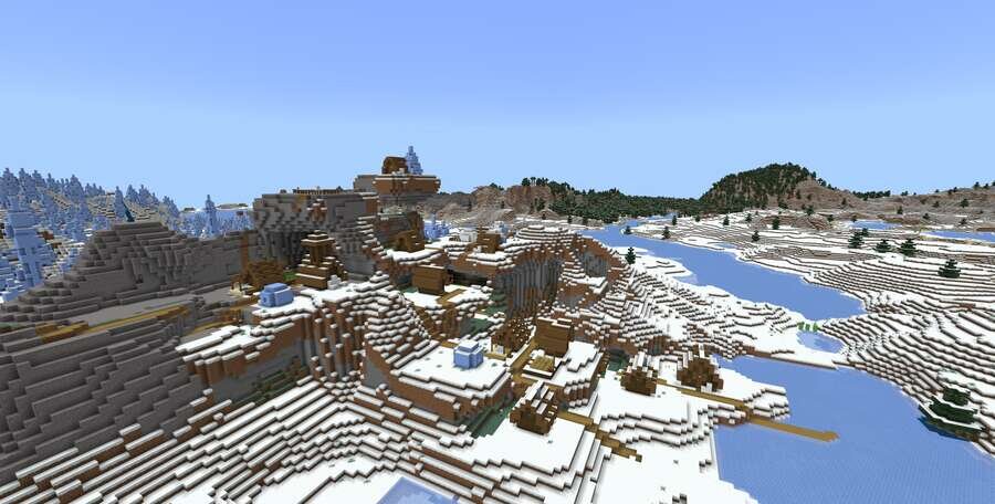 Красивая, небольшая деревушка на фоне замерзшей воды