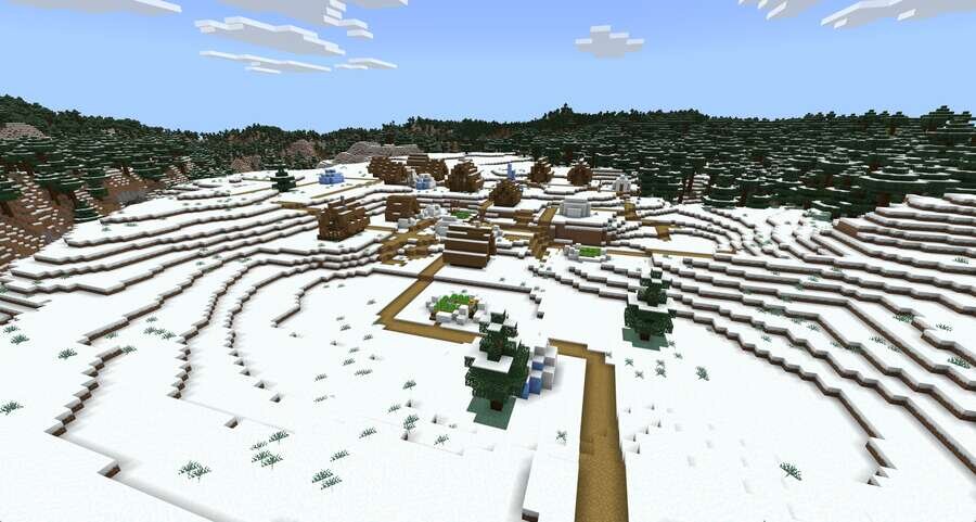 Уютная деревушка на снежной поляне рядом с густым лесом