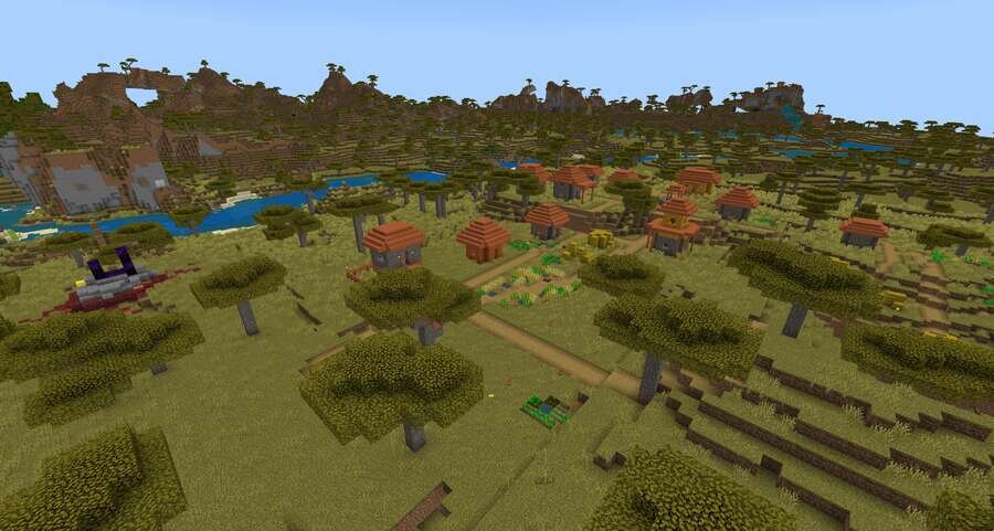 Вид на деревню на фоне полей и гор