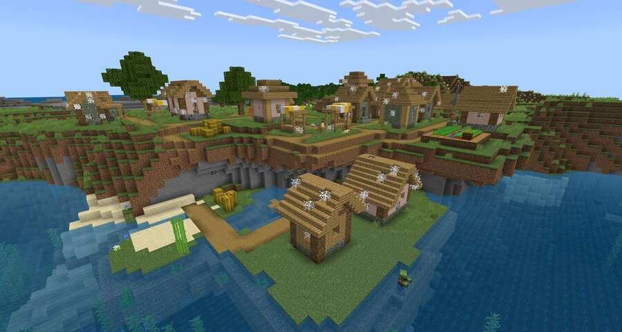 Разрушенные домики на фоне поля и воды