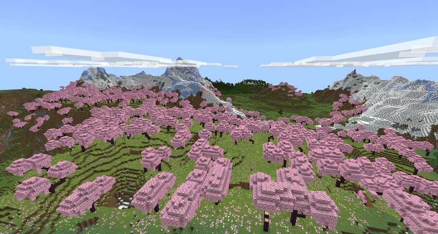 Вишневые деревья на фоне высокой горы и зеленых лугов