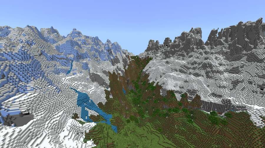 Вид на горную долину со снежными горами сверху